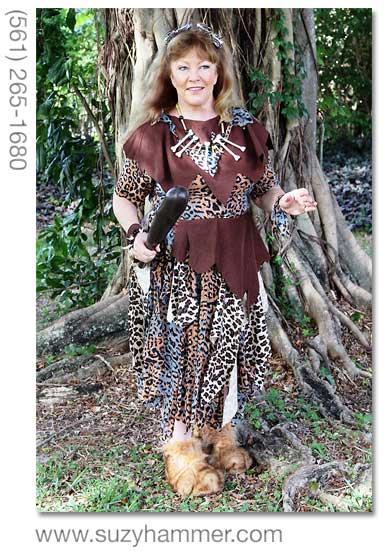 Oooga beside a tree, holding her cavewoman club.