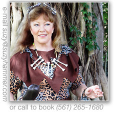 Oooga with her club by a tree.